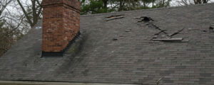 Does homeowners insurance cover roof damage in Indiana - storm damaged roof shingles on NWI home