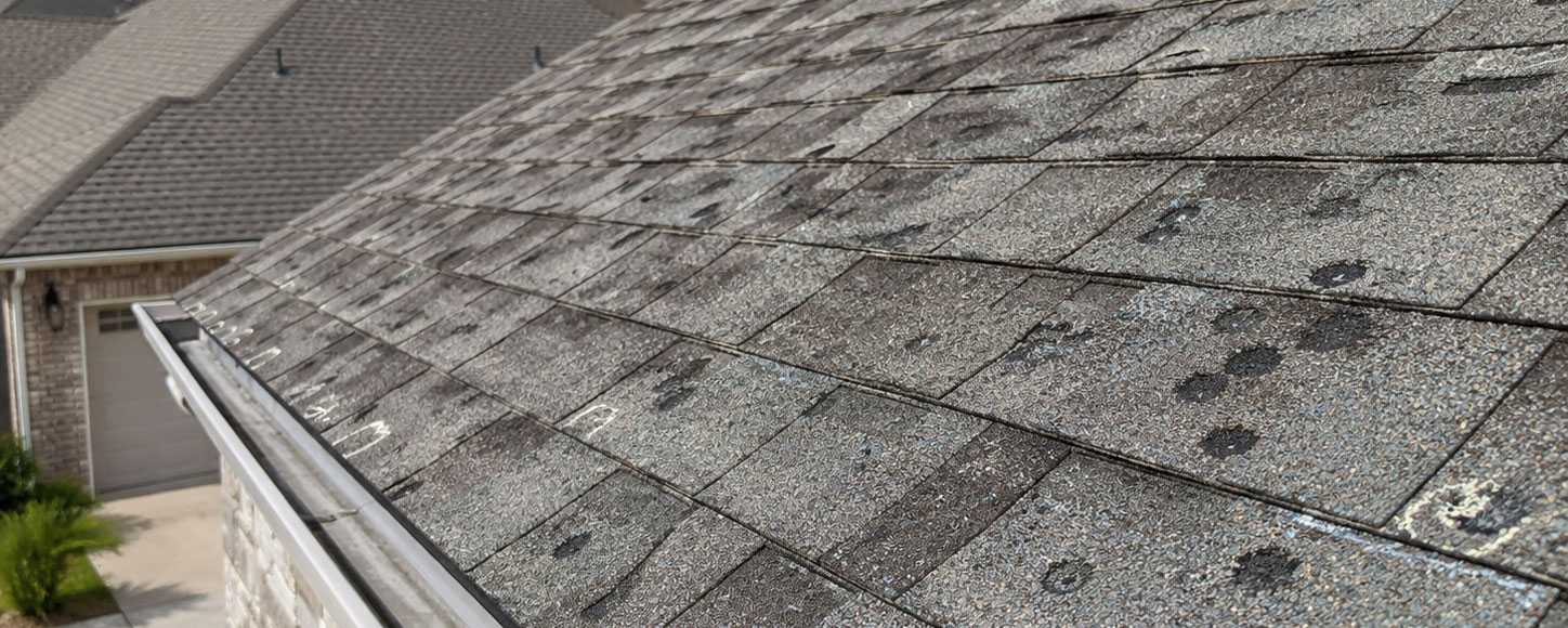 Hail damage roof Porter County Indiana home with dented asphalt shingles after a storm