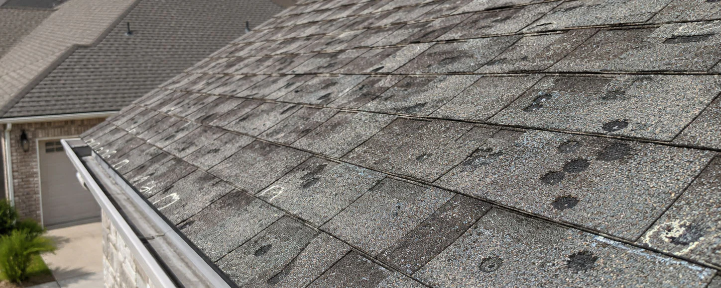 Hail damage roof Porter County Indiana home with dented asphalt shingles after a storm
