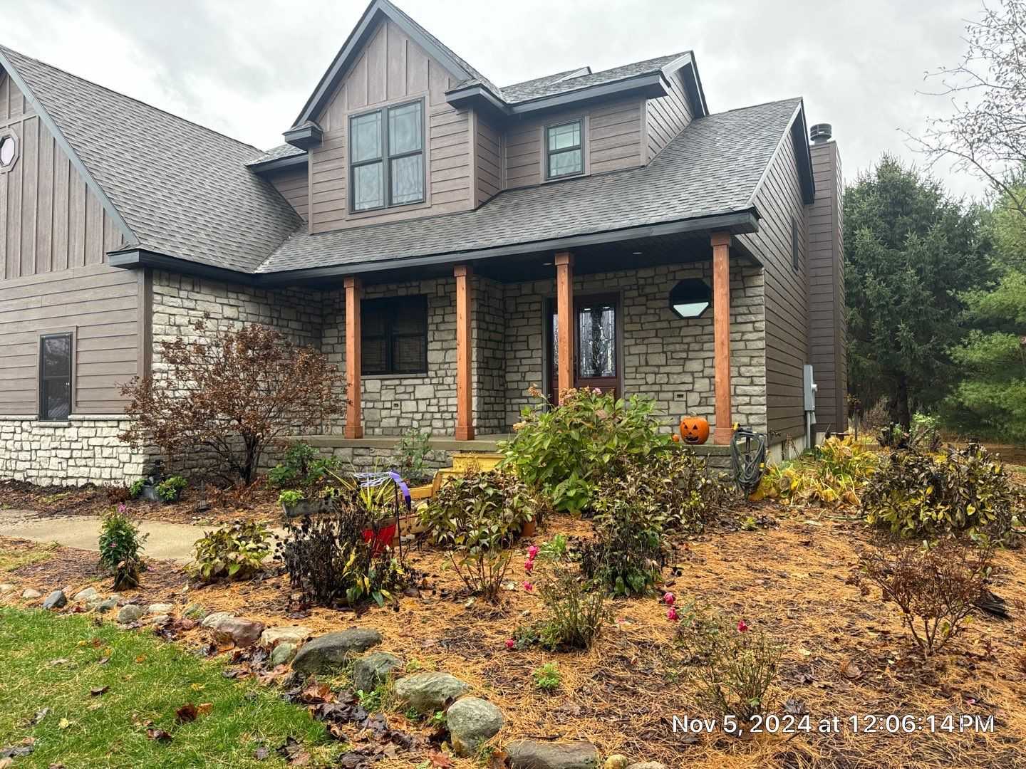 Front entry view of Westville siding, stone, windows, doors, and deck project