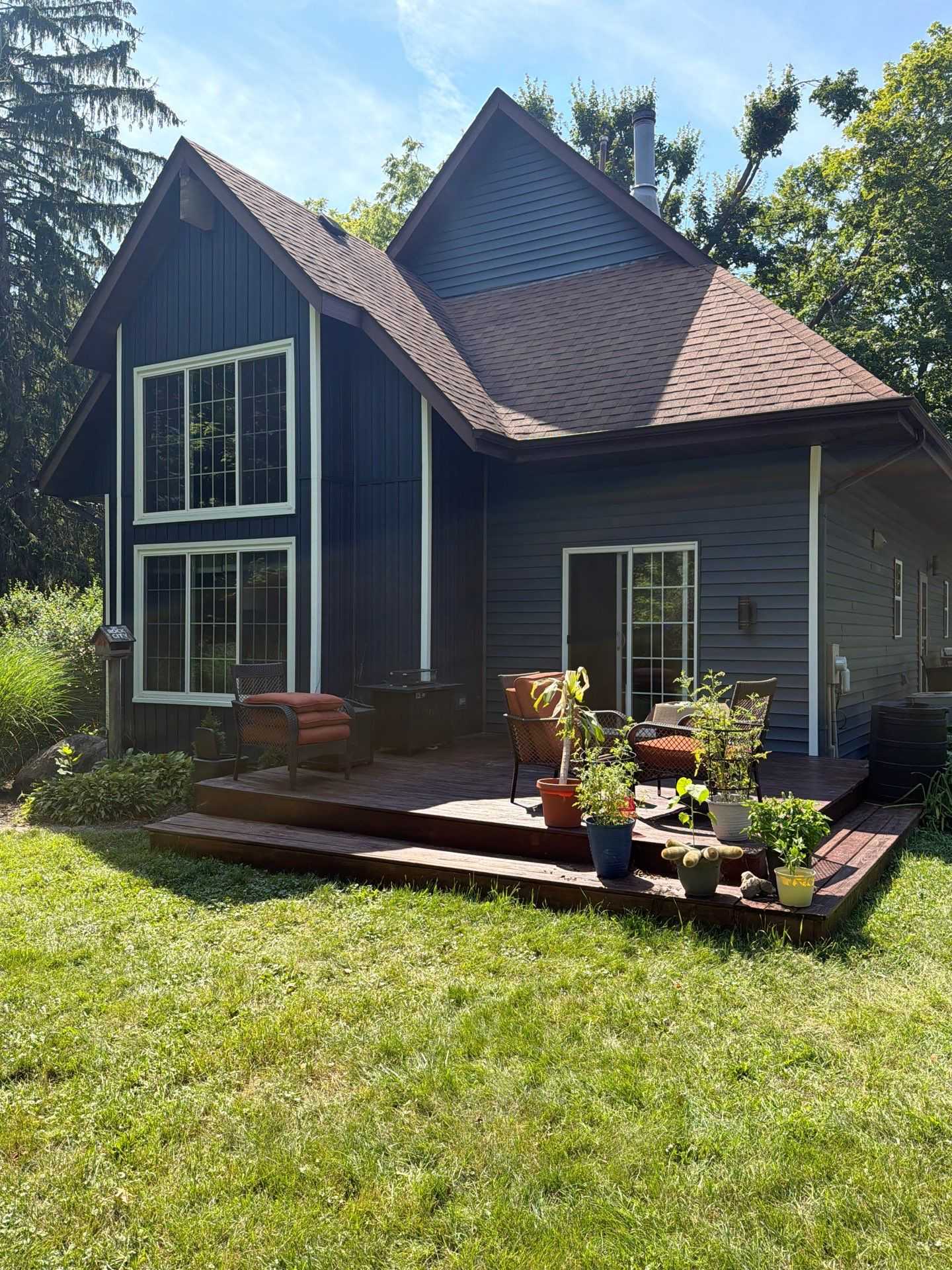 Front of a Westville home after new deep blue lap siding and board-and-batten accents were installed.