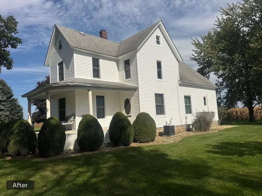 Front porch and side of a Valparaiso home after installation of white vinyl siding, replacement windows, soffit and fascia.
